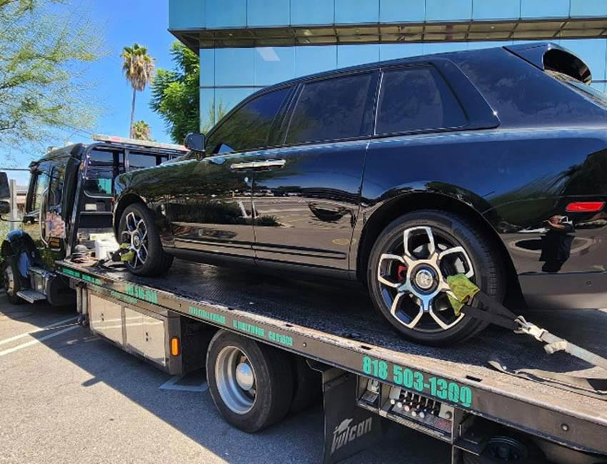 Black-SUV-sitting-on-Mid-Valley-Towing-Tow-Truck-in-North-Hollywood-California Black SUV sitting on Mid Valley Towing Flatbed Tow Truck in North Hollywood California