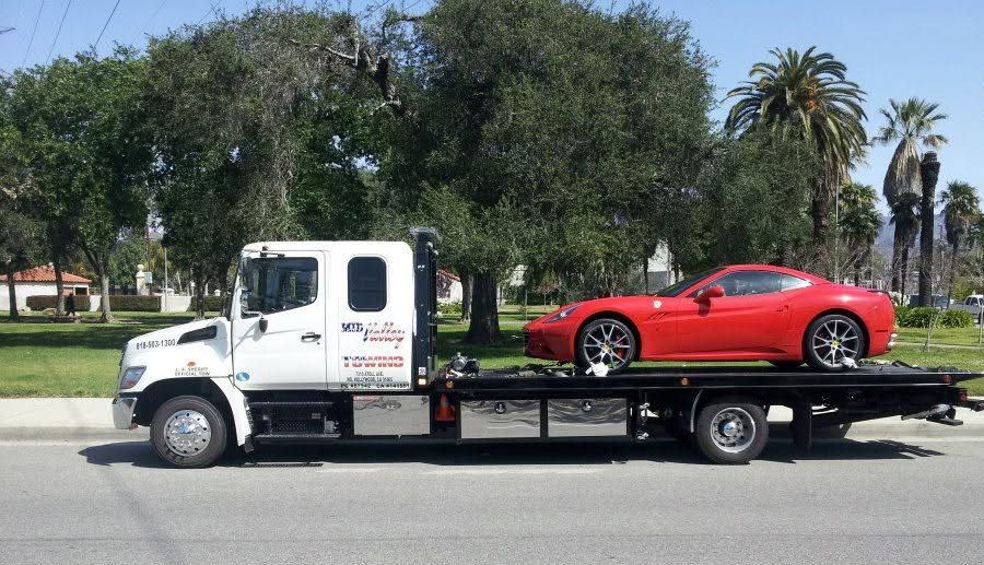 Red-sports-car-being-towed-by-Mid-Valley-Towing-in-North-Hollywood-California Red Sports car being towed by Mid Valley Towing in North Hollywood California